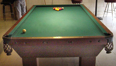 Pool table with only two pockets at one end for playing the billiard game of Corners